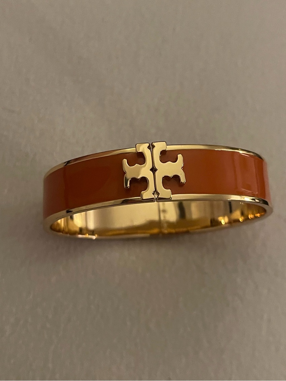 Tory Burch Gold-Tone Bangle Bracelet with Orange Enamel Logo Accent